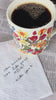model drinking coffee out of colorful floral mug