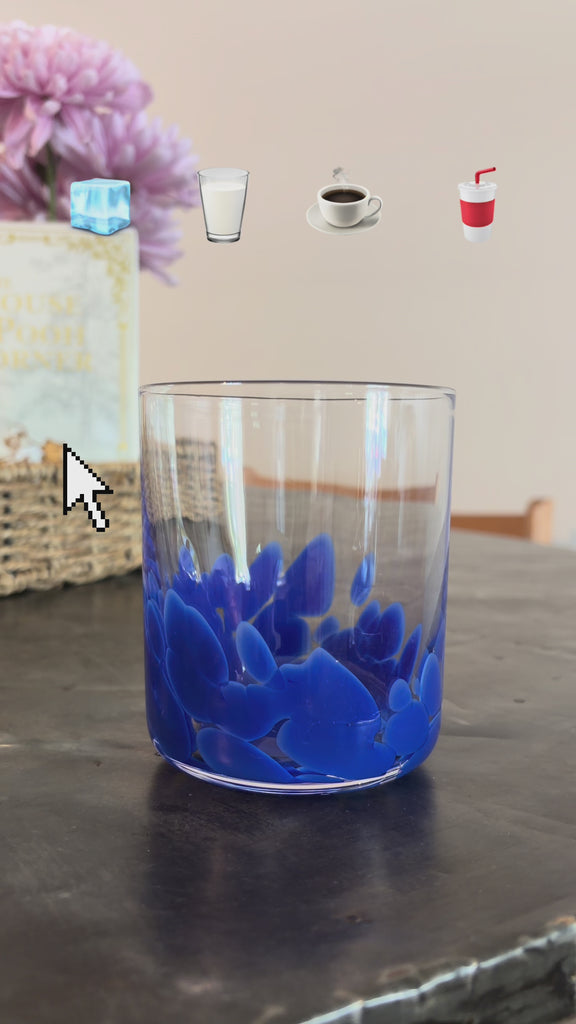 model making a coffee drink in a glass cup with blue design on the bottom