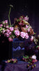 Book-shaped vase with 'Velaris' design with a bouquet inside
