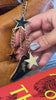 model holding black mountain and star bag charm