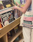model wearing colorful bookstack tote