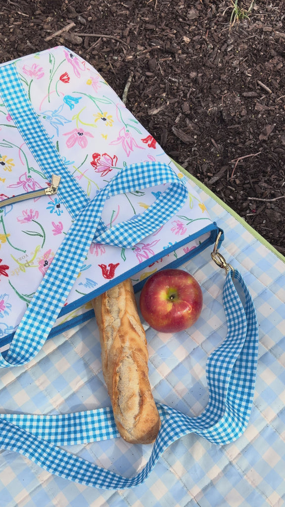 model showcasing white cooler bag with colorful sketch floral print