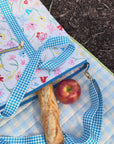 model showcasing white cooler bag with colorful sketch floral print