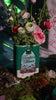 Book-shaped vase with 'Tamlin's Manor' design with flowers inside