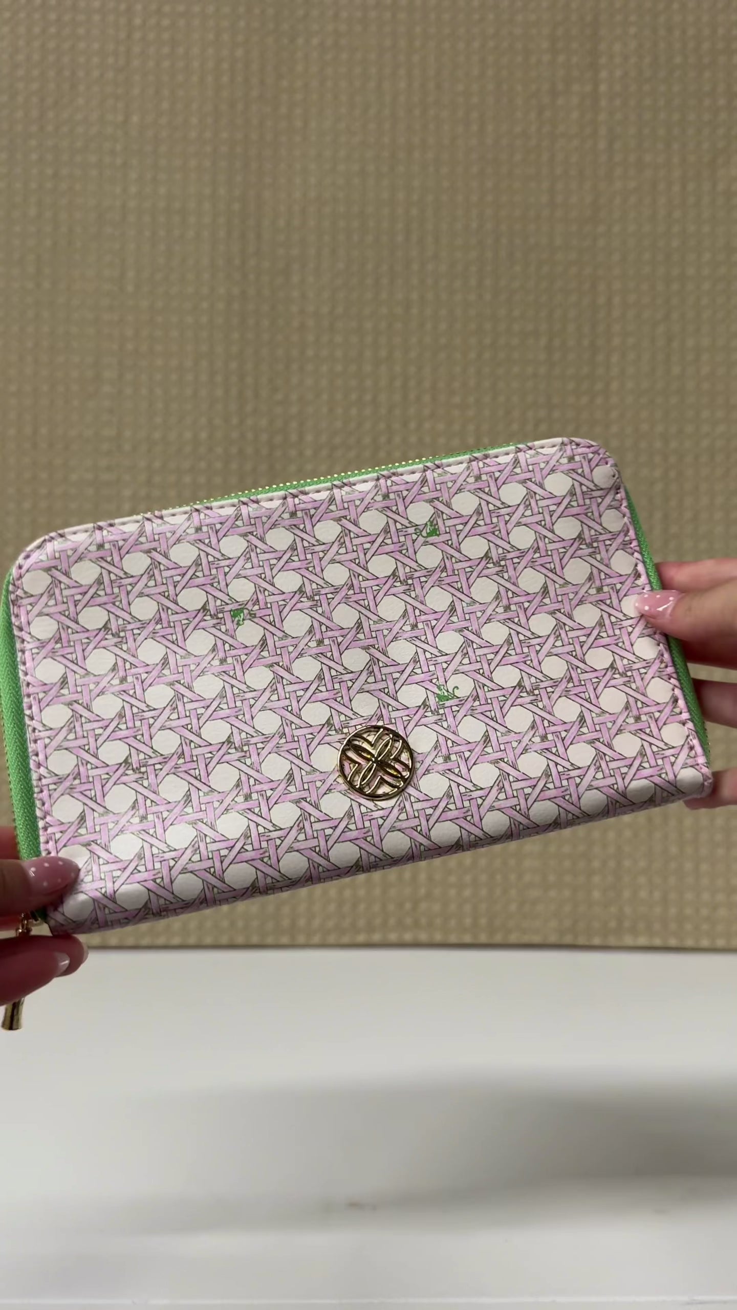model showcasing pink and green travel wallet