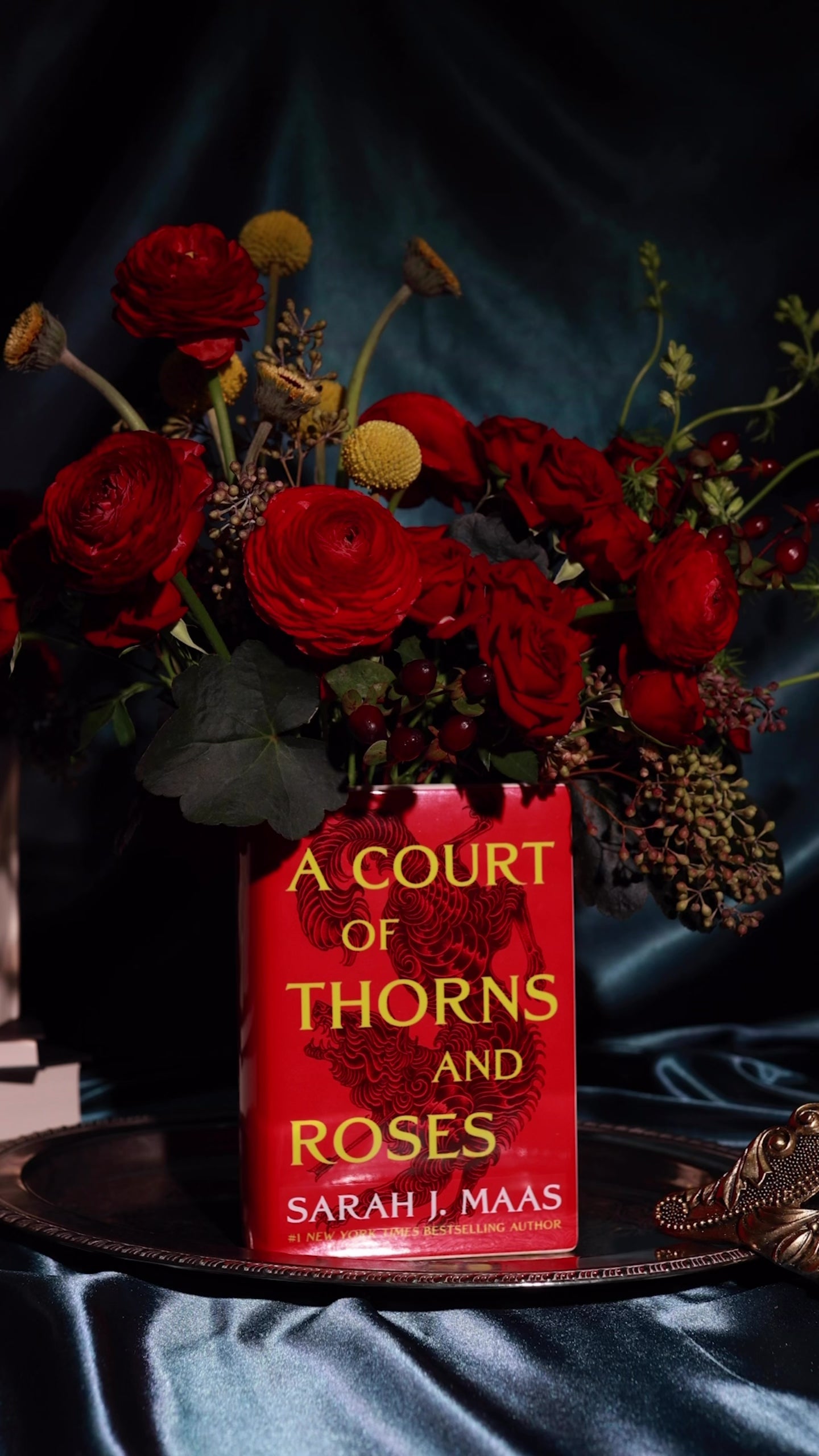 Book-shaped vase with 'A Court of Thorns and Roses' design with  bouquet inside
