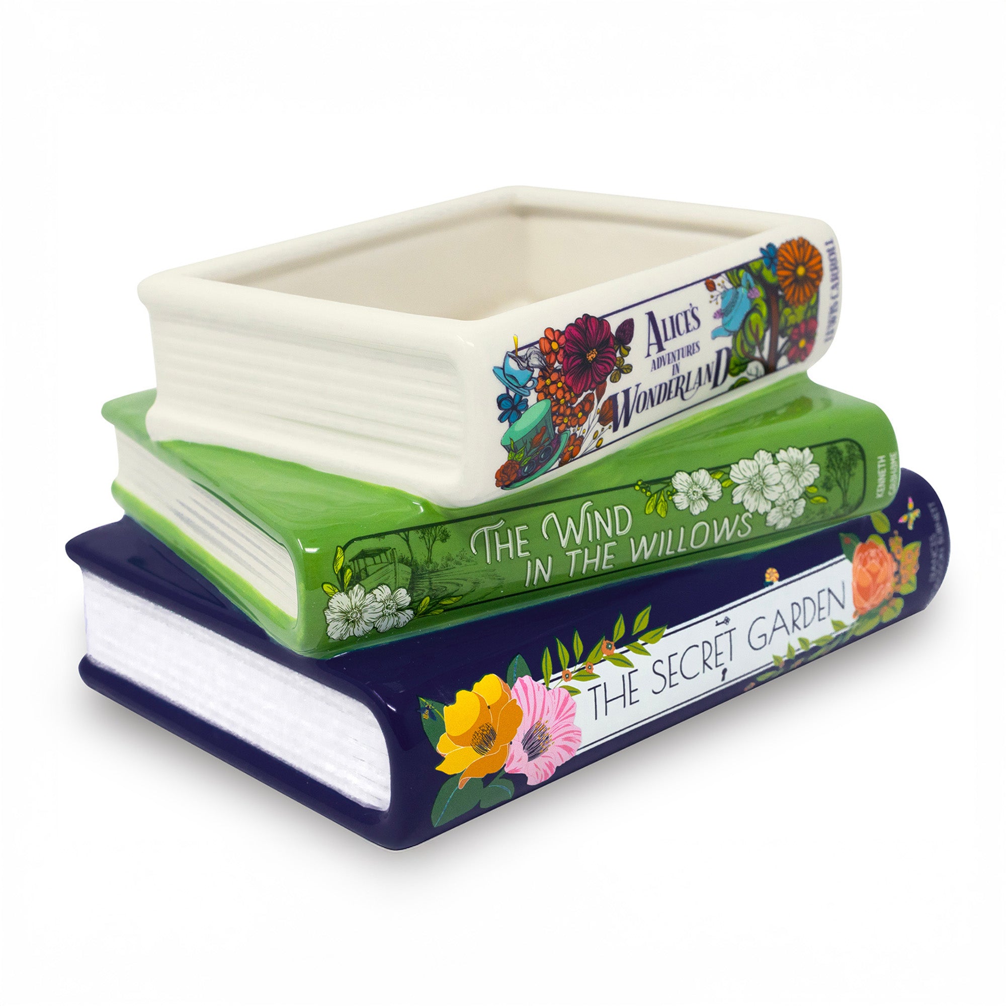 Stack of ceramic book-shaped planters with book title designs on a white background